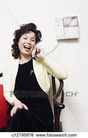 Portrait of a businesswoman talking on the telephone laughing View Large Photo Image Stock Photo - Portrait of a businesswoman talking on the telephone laughing. Fotosearch