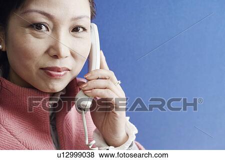 Stock Photo - Portrait of a businesswoman talking on the telephone. Fotosearch