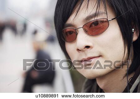 Close-up of a young man wearing headphones View Large Photo Image Stock Image - Close-up of a young man wearing headphones. Fotosearch