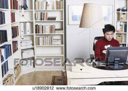 High angle view of a businessman using a computer View Large Photo Image Stock Image - High angle view of a businessman using a computer. Fotosearch
