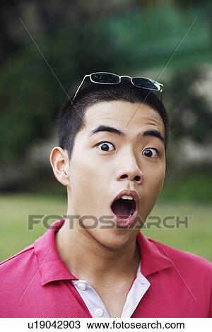 Portrait of a young man looking surprised View Large Photo Image Stock Image - Portrait of a young man looking surprised. Fotosearch