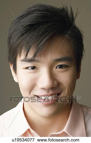 Portrait of a young man smiling View Large Photo Image Stock Photo - Portrait of a young man smiling. Fotosearch