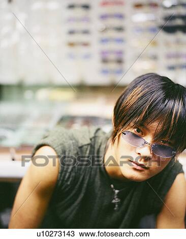 Portrait of a young man wearing sunglasses View Large Photo Image Stock Image - Portrait of a young man wearing sunglasses. Fotosearch