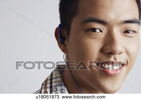 Portrait of a young man wearing headphones View Large Photo Image Stock Image - Portrait of a young man wearing headphones. Fotosearch