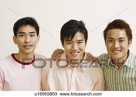 Portrait of two young men and a mid adult man posing and smiling View Large Photo Image Stock Image - Portrait of two young men and a mid adult man posing and smiling. Fotosearch