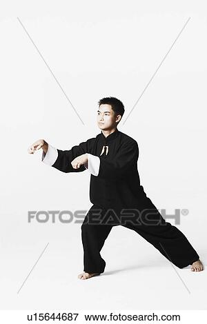 Stock Photo - Young man practicing martial arts. Fotosearch