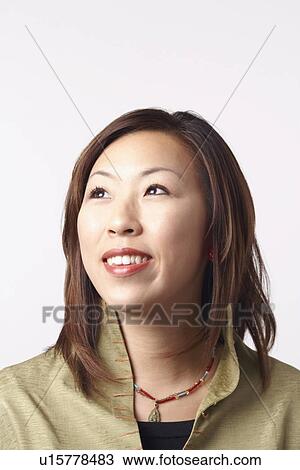 Stock Image - Close-up of a businesswoman looking up. Fotosearch
