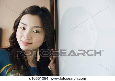 Close-up of a young woman smiling View Large Photo Image Picture - Close-up of a young woman smiling. Fotosearch