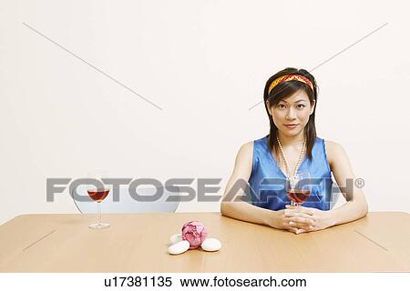 Stock Photography - Portrait of a young woman holding a glass of wine. Fotosearch