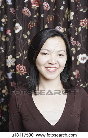 Stock Image - Portrait of a young woman smiling. Fotosearch