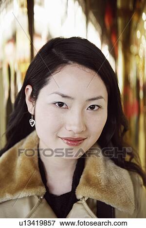 Stock Photo - Portrait of a young woman smiling. Fotosearch
