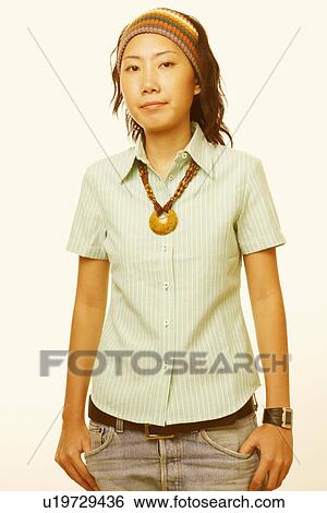 Portrait of a young woman wearing a necklace View Large Photo Image Stock Photograph - Portrait of a young woman wearing a necklace. Fotosearch