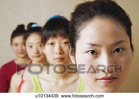 Stock Photo - Portrait of four young women in a row. Fotosearch