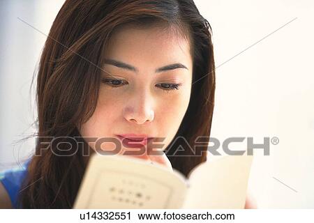 Closed Up Image of a Young Adult Woman Reading a Book, Low Angle View, Differential Focus View Large Photo Image Stock Image - Closed Up Image of a Young Adult Woman Reading a Book, Low Angle View, Differential Focus. Fotosearch