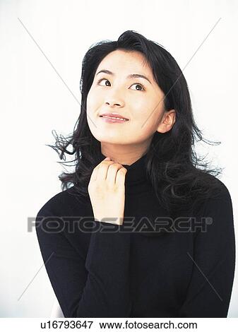 Stock Photo - Image of a Mid Adult Woman in a Black Sweater Smiling, Looking Up, Front View. Fotosearch