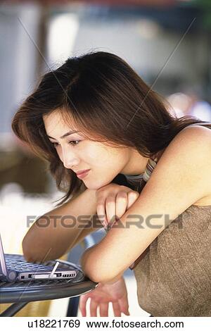 Image of a Mid Adult Woman Looking at her Computer, Smiling, Side View, Differential Focus View Large Photo Image Stock Photo - Image of a Mid Adult Woman Looking at her Computer, Smiling, Side View, Differential Focus. Fotosearch