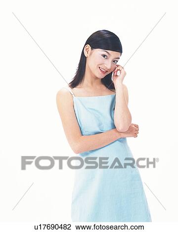 Stock Image - Image of a Mid Adult Woman Posing in a Blue Dress, Smiling, Looking at Camera, Front View. Fotosearch