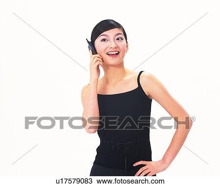 Stock Image - Image of a Mid Adult Woman Talking on the Phone, Smiling, Dressed in Black, Front View. Fotosearch