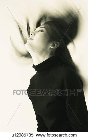 Stock Photography - Image of a Young Adult Woman Flipping her Hair Back, Smiling, Blurred Motion, Side View. Fotosearch