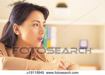 Image of a Young Adult Woman Standing Next to a Bookcase, Side View, Differential Focus View Large Photo Image Stock Photography - Image of a Young Adult Woman Standing Next to a Bookcase, Side View, Differential Focus. Fotosearch
