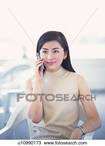 Image of a Young Adult Woman Talking on the Phone, Smiling, Looking Sideways, Front View View Large Photo Image Stock Image - Image of a Young Adult Woman Talking on the Phone, Smiling, Looking Sideways, Front View. Fotosearch