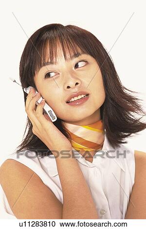 Image of a Young Adult Woman Talking on the Phone, Looking Sideways, Smiling, Front View View Large Photo Image Stock Image - Image of a Young Adult Woman Talking on the Phone, Looking Sideways, Smiling, Front View. Fotosearch