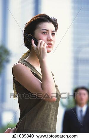 Image of a Young Adult Woman Talking on the Phone Outside, Side View, Low Angle View, Differential Focus View Large Photo Image Stock Image - Image of a Young Adult Woman Talking on the Phone Outside, Side View, Low Angle View, Differential Focus. Fotosearch
