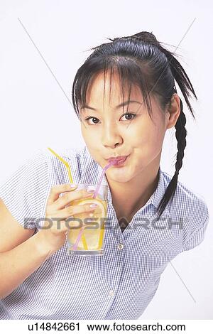 Japanese woman bending down and drinking from straw View Large Photo Image Stock Image - Japanese woman bending down and drinking from straw. Fotosearch