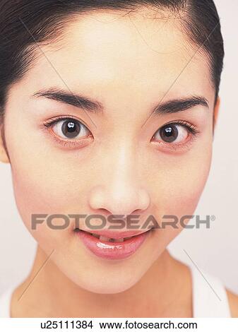 Picture - Japanese woman smiling and looking at camera, close up. Fotosearch
