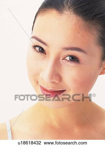 Stock Image - Japanese woman smiling to camera. Fotosearch