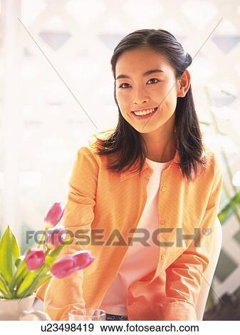 Pink tulips and Japanese woman smiling View Large Photo Image Stock Photo - Pink tulips and Japanese woman smiling. Fotosearch