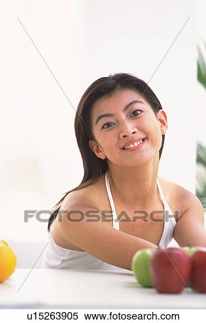 Portrait of Japanese woman leaning on table, smiling View Large Photo Image Stock Photography - Portrait of Japanese woman leaning on table, smiling. Fotosearch