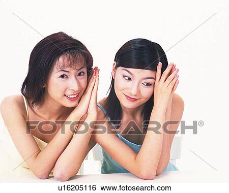 Stock Photograph - Two women putting elbows on the table, portrait of one. Fotosearch