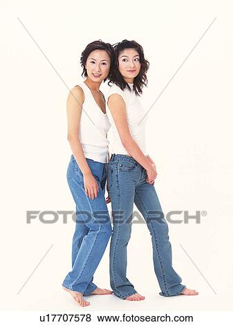 Stock Photo - Two women standing close, portrait of one. Fotosearch