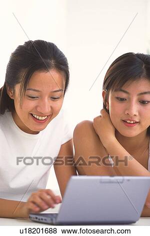 Stock Photo - Two women using laptop. Fotosearch