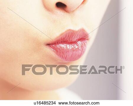 Picture - Woman puckering rouged lips . Fotosearch