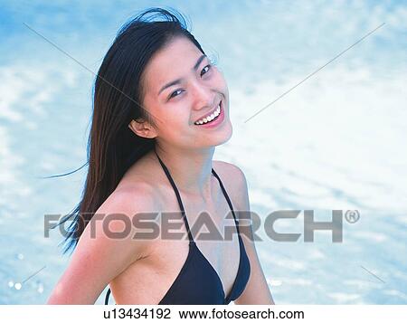 Woman wearing bathing suit, smiling at the side of the pool View Large Photo Image Stock Image - Woman wearing bathing suit, smiling at the side of the pool . Fotosearch