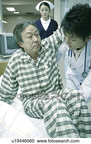 Stock Image - Doctor and nurse and patient. Fotosearch