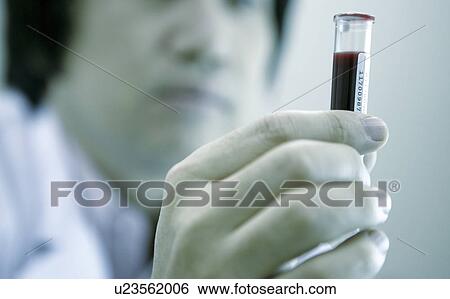 Stock Photograph - Doctor holding a vial. Fotosearch