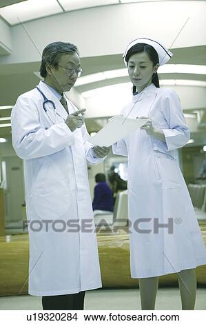 Nurse listening to doctor View Large Photo Image Picture - Nurse listening to doctor . Fotosearch