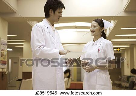 Nurse listening to doctor View Large Photo Image Stock Photography - Nurse listening to doctor . Fotosearch