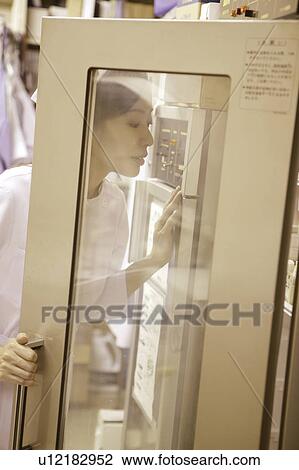 Nurse looking for the medicine View Large Photo Image Stock Image - Nurse looking for the medicine. Fotosearch