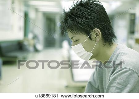 Stock Image - Young man patient in a mask . Fotosearch
