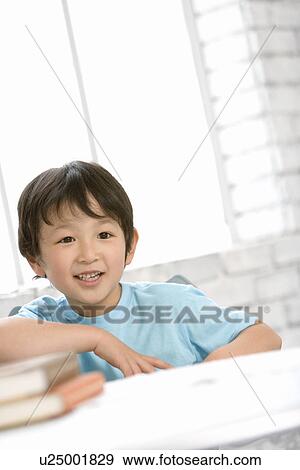 Photography of a boy and books, Low Angle View View Large Photo Image Stock Photo - Photography of a boy and books, Low Angle View. Fotosearch