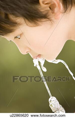 Photography of a boy drinking water, Close Up, Low Angle View View Large Photo Image Stock Image - Photography of a boy drinking water, Close Up, Low Angle View. Fotosearch