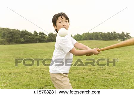 Stock Image - Photography of a boy playing baseball, High Angle View. Fotosearch