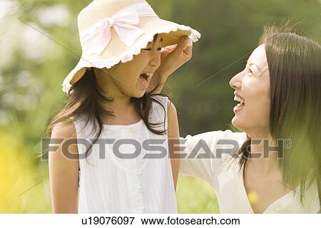 Stock Photo - Photography of a daughter and mother in the field, Differential Focus. Fotosearch