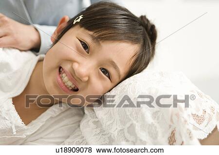 Stock Photo - Photography of a daughter lying on mother's lap, Low Angle View. Fotosearch