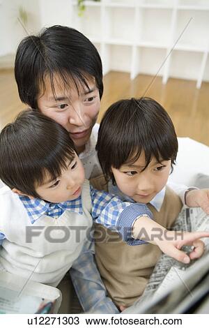 Photography of a father and children reading news paper, High Angle View View Large Photo Image Stock Image - Photography of a father and children reading news paper, High Angle View. Fotosearch