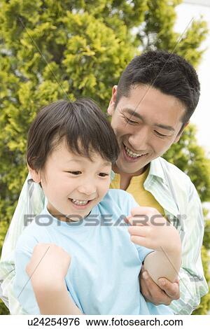 Photography of a father and son, Low Angle View View Large Photo Image Stock Photograph - Photography of a father and son, Low Angle View. Fotosearch